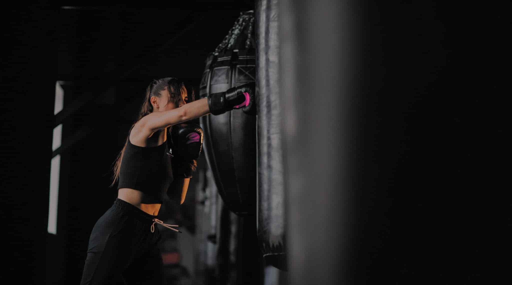 A woman punching a punching bag